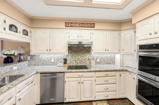 kitchen with stainless steel appliances, light stone counters, backsplash, and under cabinet range hood