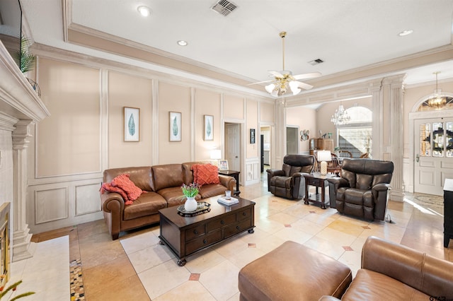 living area with visible vents, a decorative wall, and ornate columns