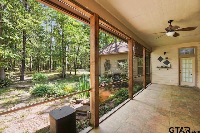 unfurnished sunroom with a ceiling fan