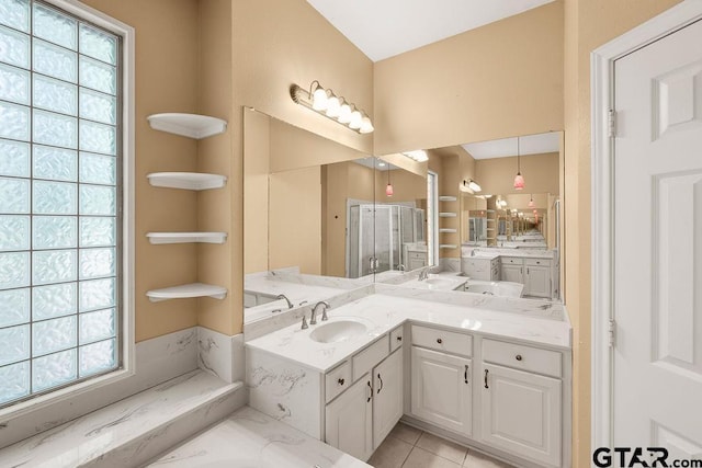 bathroom featuring tile patterned floors, vanity, and a shower stall