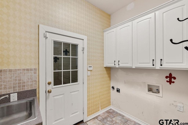 clothes washing area featuring a sink, wallpapered walls, hookup for an electric dryer, cabinet space, and washer hookup