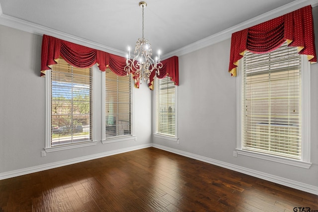 unfurnished dining area featuring dark wood-type flooring, ornamental molding, baseboards, and an inviting chandelier
