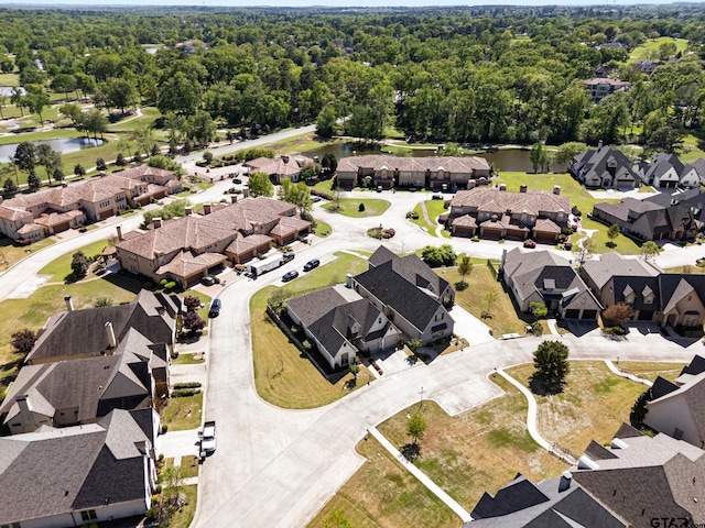 birds eye view of property with a water view, a residential view, and a forest view