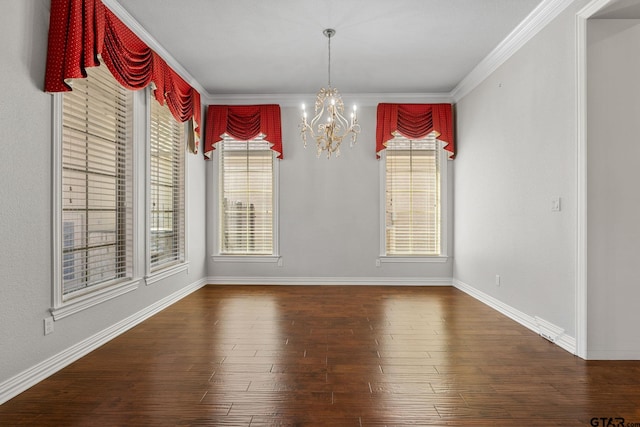 unfurnished dining area with a chandelier, baseboards, crown molding, and wood finished floors