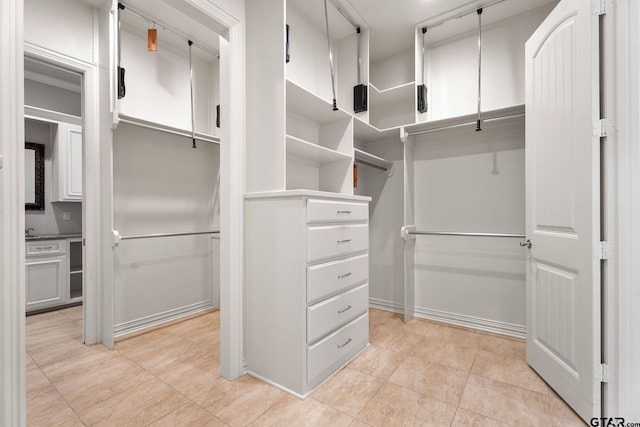 walk in closet featuring light tile patterned flooring