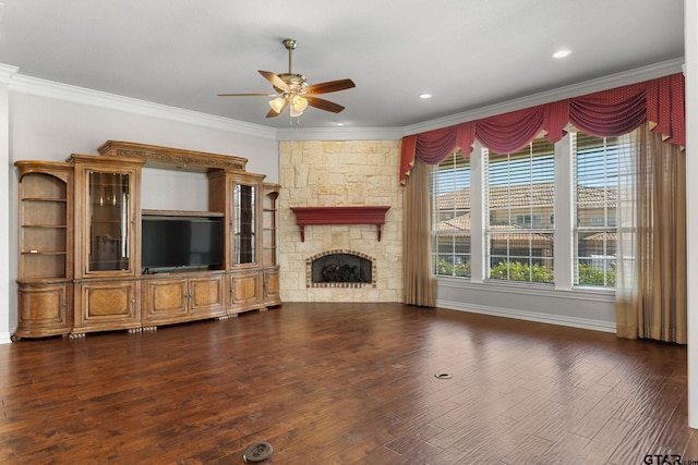 unfurnished living room with baseboards, ornamental molding, a fireplace, dark wood-type flooring, and ceiling fan