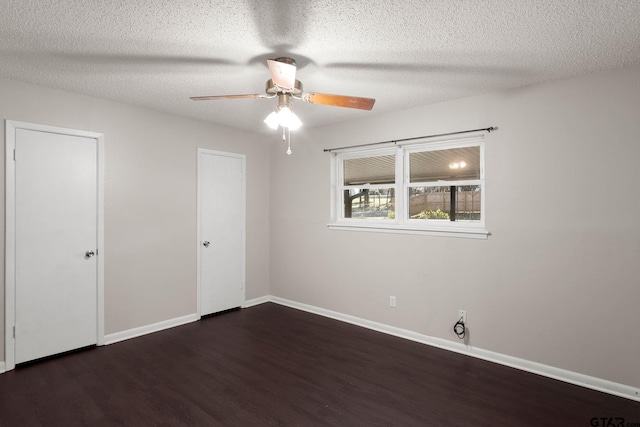 unfurnished bedroom with ceiling fan, dark hardwood / wood-style floors, and a textured ceiling