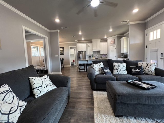 living room with ornamental molding, dark hardwood / wood-style floors, and a wealth of natural light