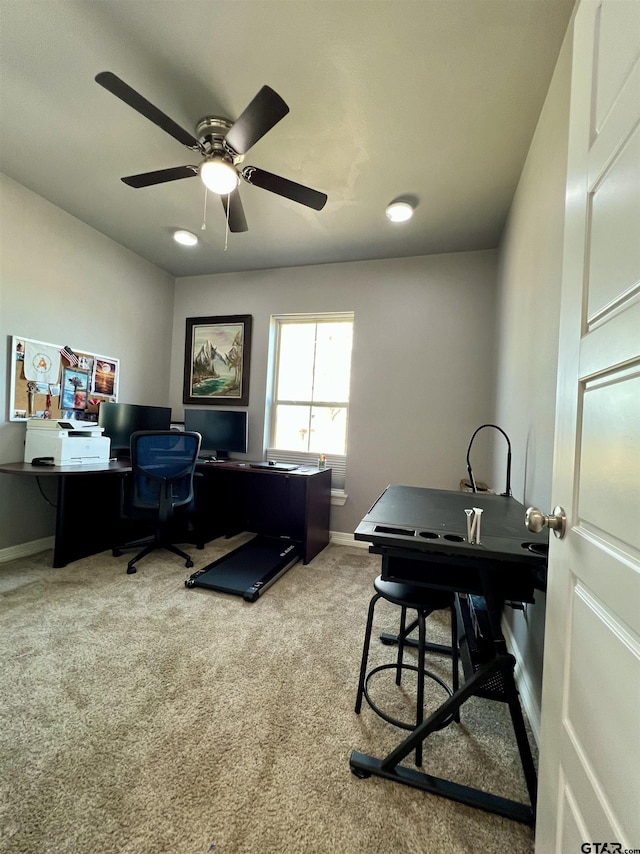 carpeted office space with ceiling fan