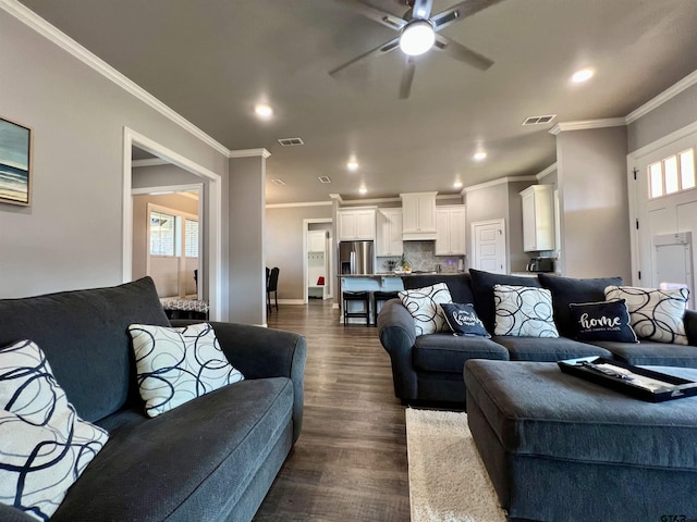 living room featuring crown molding, recessed lighting, visible vents, and dark wood finished floors