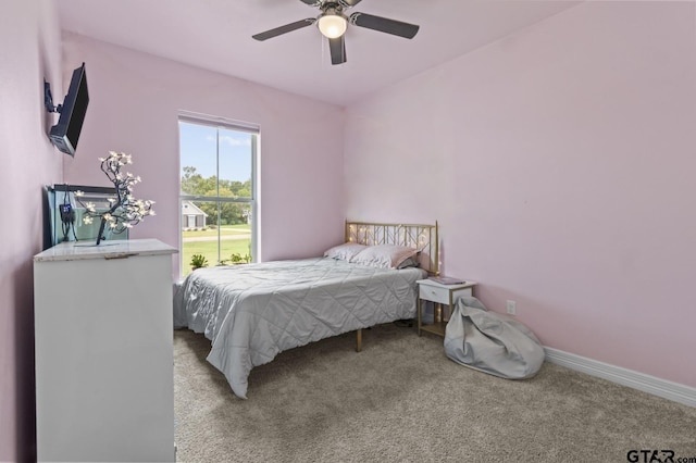 carpeted bedroom featuring ceiling fan and baseboards