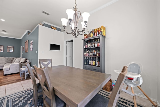 7032 La Hacienda Dr, Flint, TX 75762 - tiled dining room with ornamental molding, a chandelier, baseboards, and a dry bar