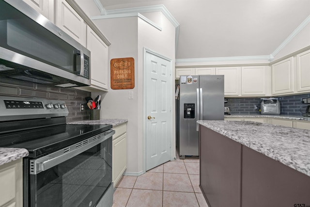 7032 La Hacienda Dr, Flint, TX 75762 - kitchen with stainless steel appliances, decorative backsplash, light tile patterned floors, ornamental molding, and white cabinets