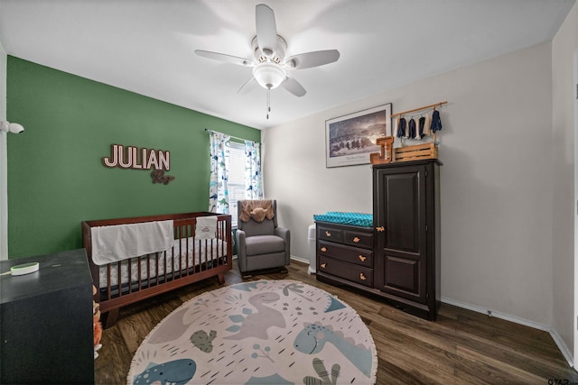 7032 La Hacienda Dr, Flint, TX 75762 - bedroom with ceiling fan, wood finished floors, a crib, and baseboards