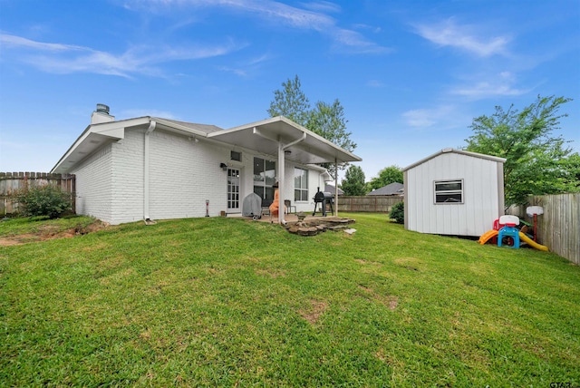 7032 La Hacienda Dr, Flint, TX 75762 - back of house with a chimney, an outdoor structure, a storage unit, a patio, and brick siding