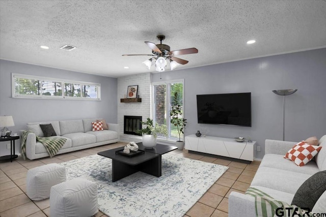 12595 Oneall St, Tyler, TX 75704 - living room with tile patterned floors, ceiling fan, a fireplace, recessed lighting, and a textured ceiling