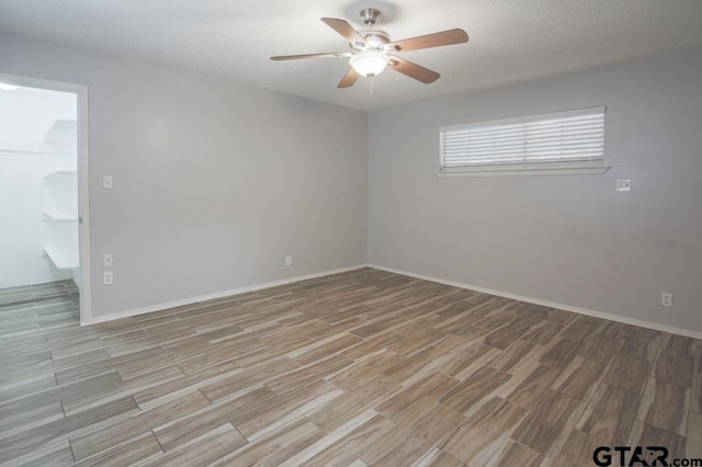 12595 Oneall St, Tyler, TX 75704 - empty room featuring light wood finished floors, ceiling fan, and baseboards