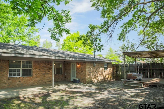 12595 Oneall St, Tyler, TX 75704 - rear view of property with fence, brick siding, and a patio area