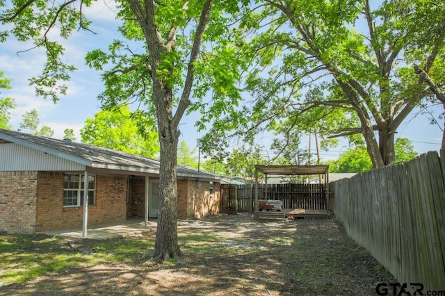 12595 Oneall St, Tyler, TX 75704 - fenced backyard featuring a patio