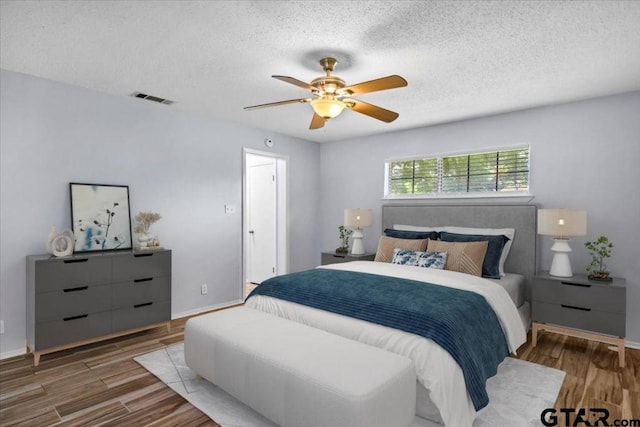 12595 Oneall St, Tyler, TX 75704 - bedroom with wood finished floors, a textured ceiling, and a ceiling fan