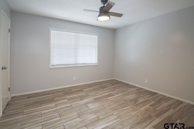 12595 Oneall St, Tyler, TX 75704 - spare room featuring ceiling fan, light wood-style flooring, a textured ceiling, and baseboards