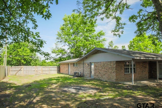12595 Oneall St, Tyler, TX 75704 - rear view of property with a fenced backyard, brick siding, a patio area, and central AC unit