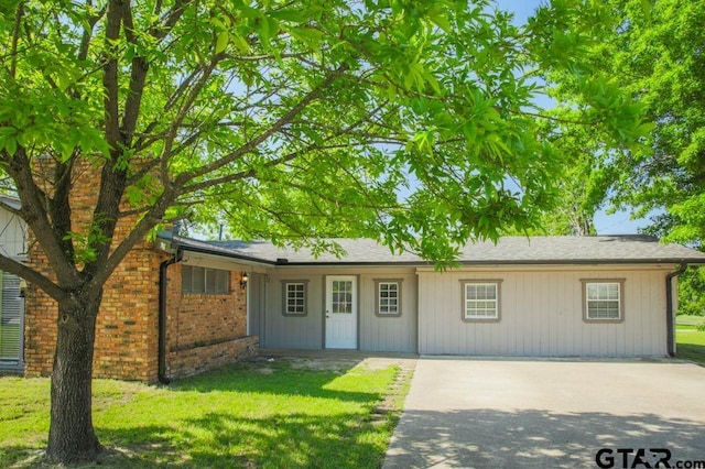12595 Oneall St, Tyler, TX 75704 - single story home featuring a front yard, a chimney, brick siding, and driveway