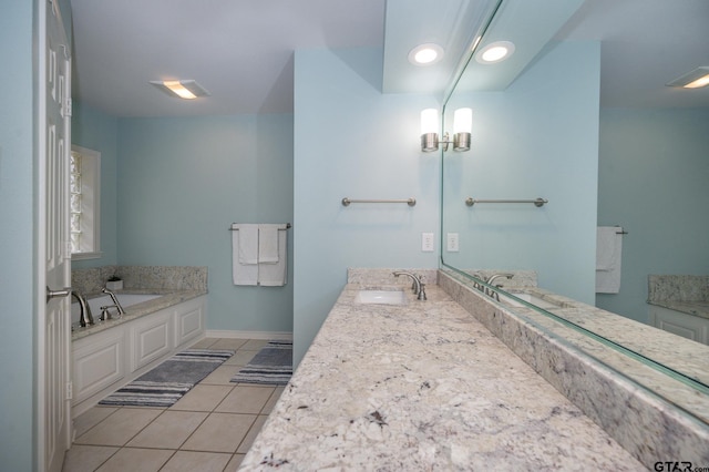 bathroom with tile patterned flooring, vanity, and a bathtub