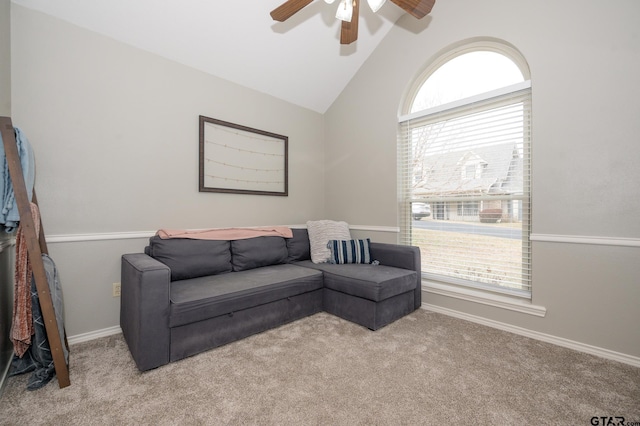 living room featuring light carpet, ceiling fan, vaulted ceiling, and a healthy amount of sunlight