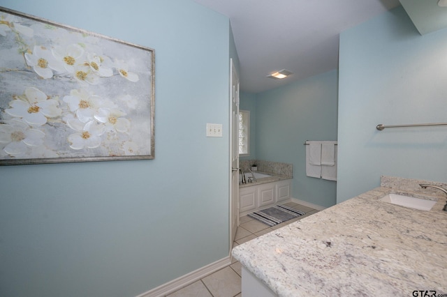 bathroom featuring vanity, a bath, and tile patterned floors