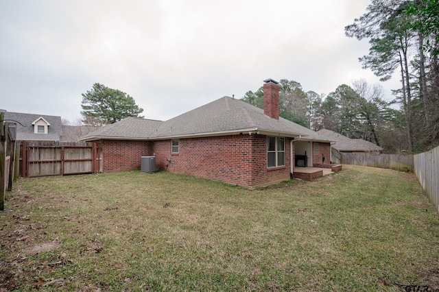 rear view of house featuring a lawn