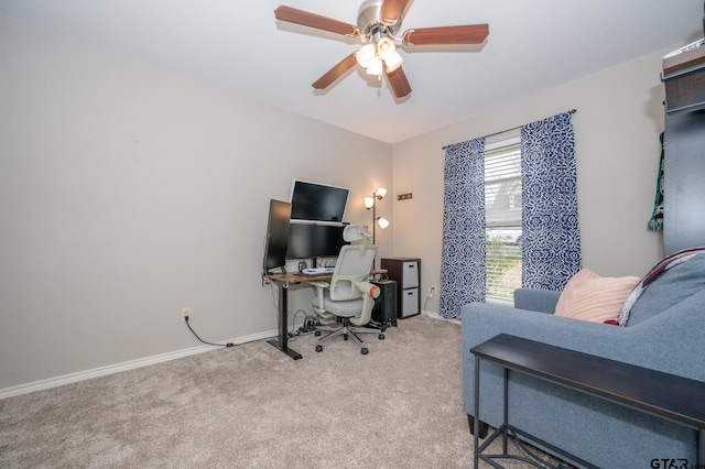 carpeted office featuring ceiling fan