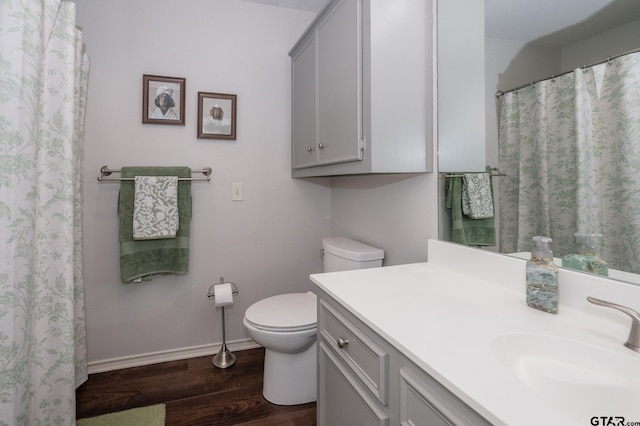 bathroom featuring hardwood / wood-style flooring, vanity, and toilet