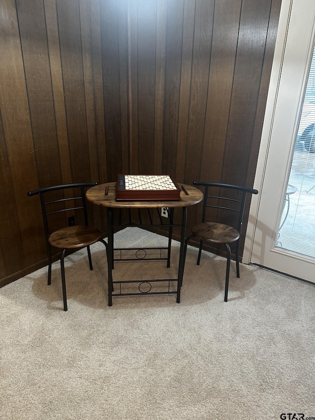 home office featuring wooden walls and light carpet