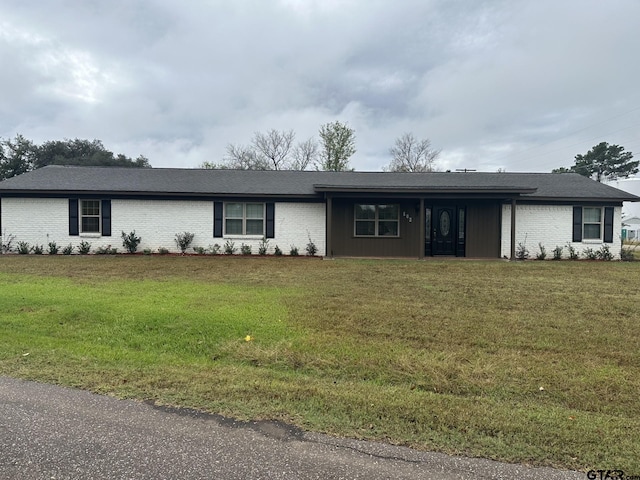 ranch-style home featuring a front yard