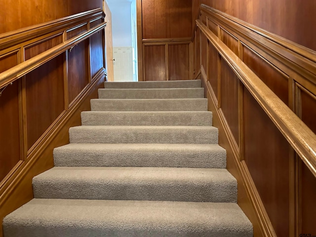 stairs with wood walls