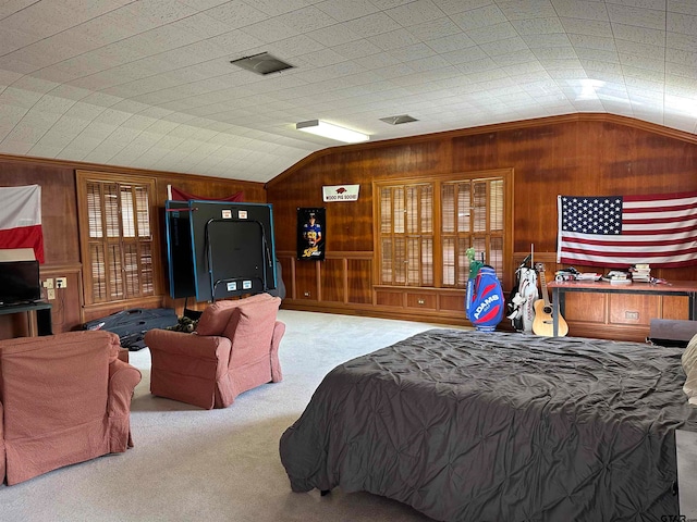 bedroom featuring wooden walls, vaulted ceiling, and carpet floors