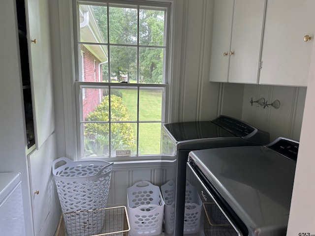 washroom with washer and clothes dryer and cabinets