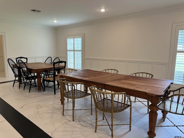 dining space with crown molding