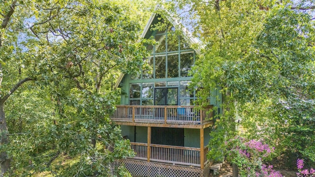 back of house featuring a wooden deck