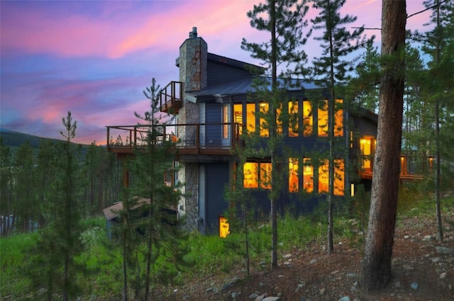 view of back house at dusk