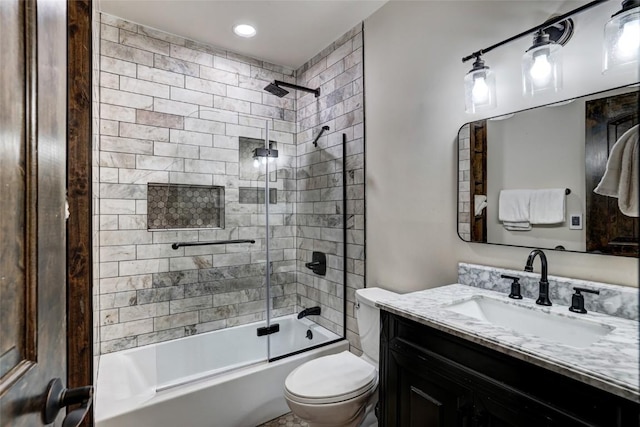 full bathroom featuring vanity, toilet, and bath / shower combo with glass door