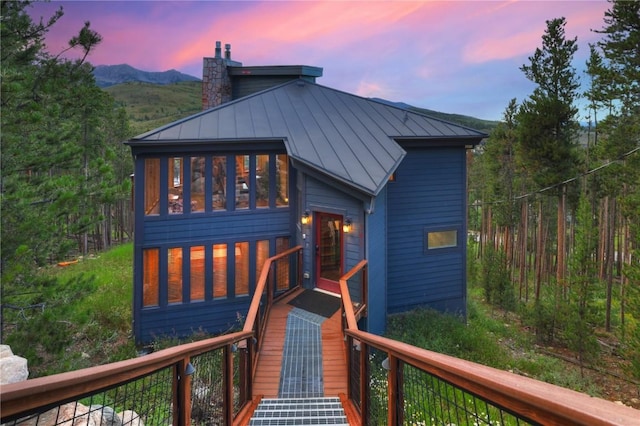 back house at dusk featuring a mountain view