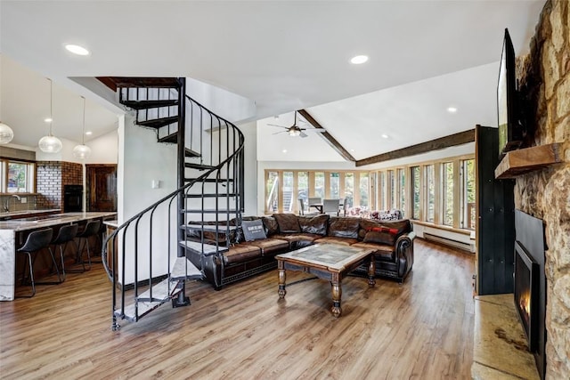 living room featuring ceiling fan, light hardwood / wood-style floors, lofted ceiling, and a wealth of natural light