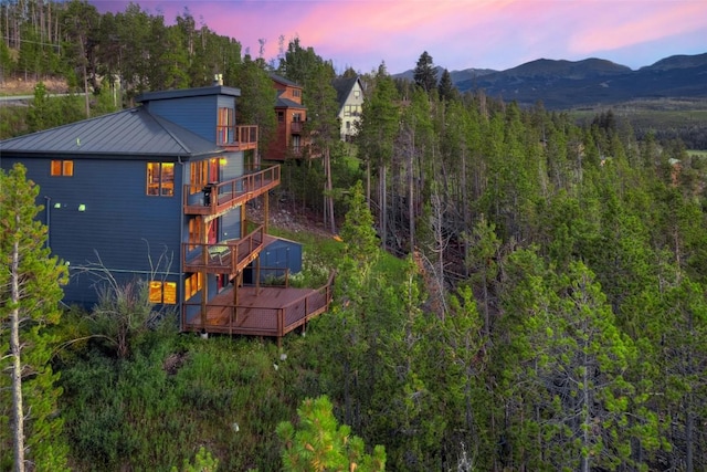 aerial view at dusk featuring a mountain view