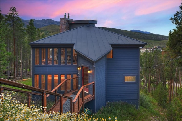 back house at dusk featuring a mountain view