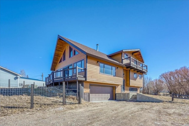 view of front facade featuring a garage and a balcony