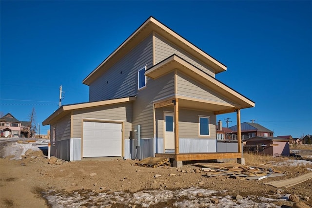 rear view of property featuring an attached garage