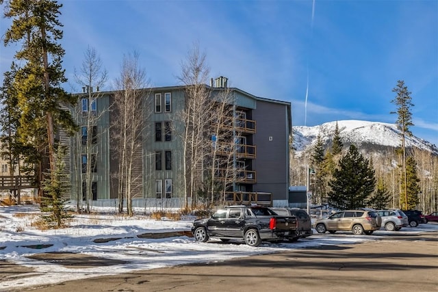 snow covered property featuring a mountain view