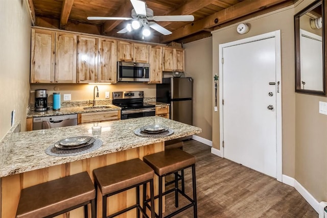 kitchen featuring beam ceiling, ceiling fan, sink, wooden ceiling, and appliances with stainless steel finishes